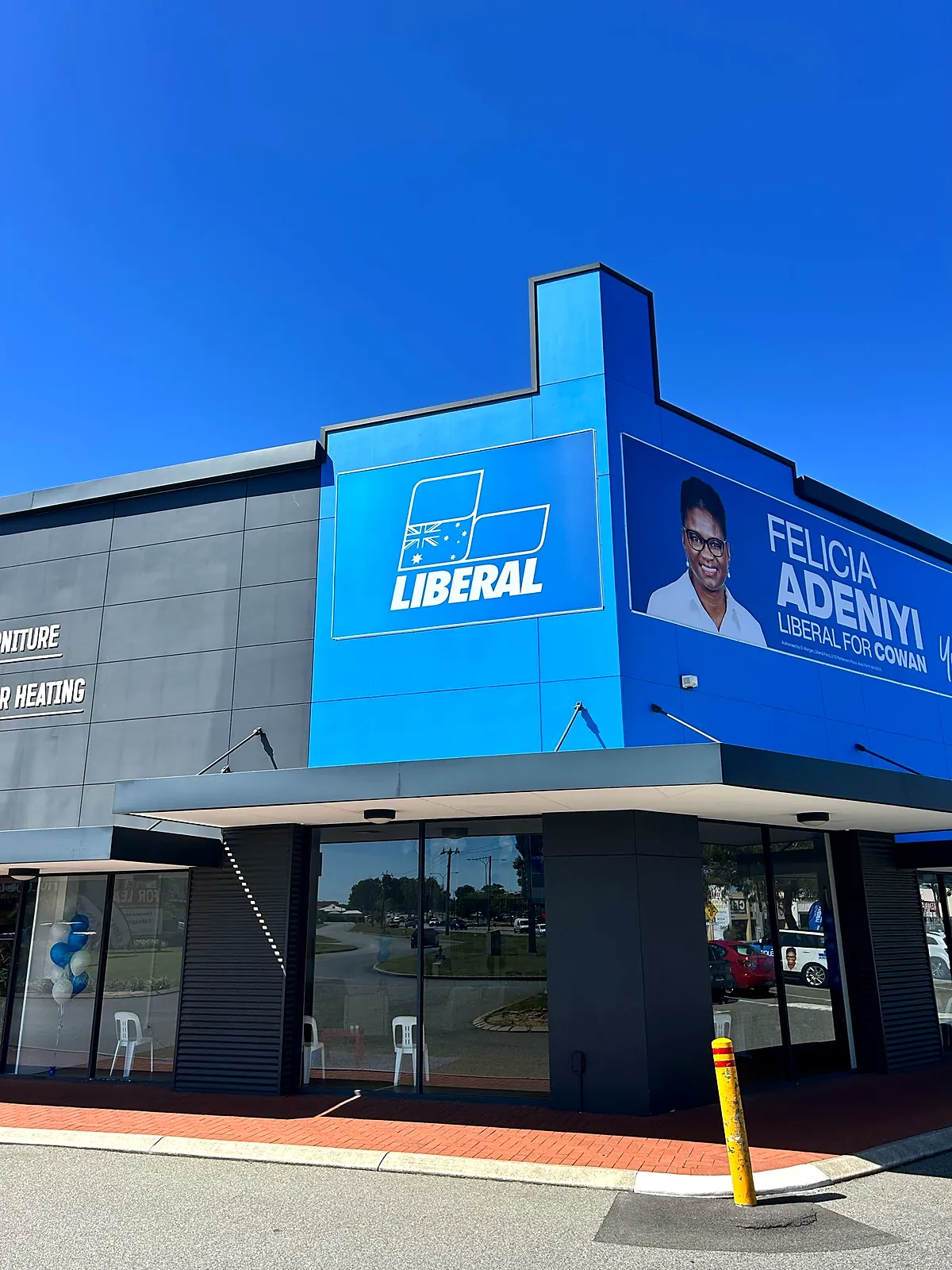 Large-format fascia signage and building banner installed on a Perth campaign office