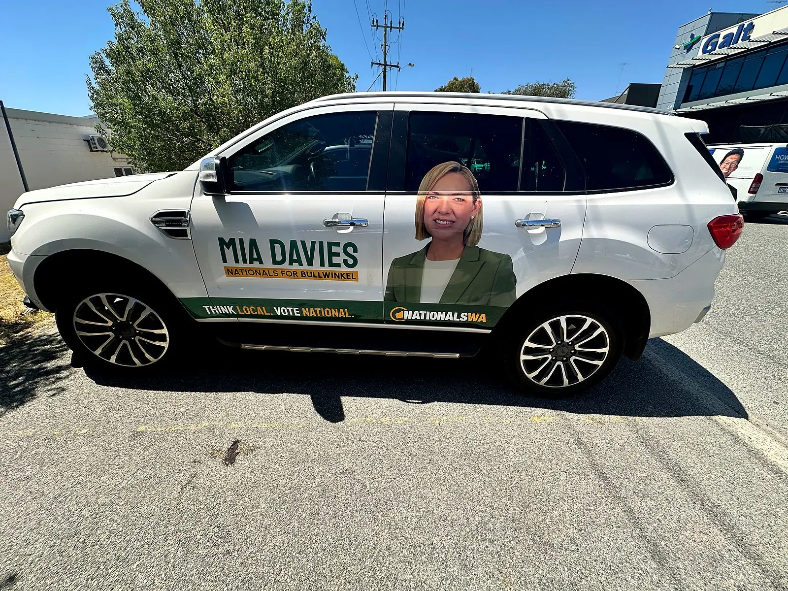 Partial vinyl wrap with printed graphics on a white SUV, printed and installed in Perth